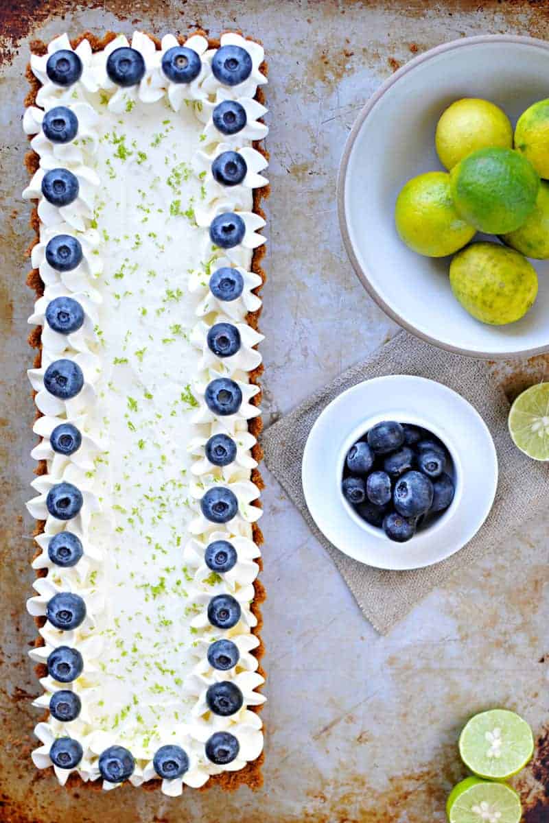 blueberry key lime cheesecake tart with gingersnap crust recipe via thepigandquill.com | #baking #sweets #dessert #summer