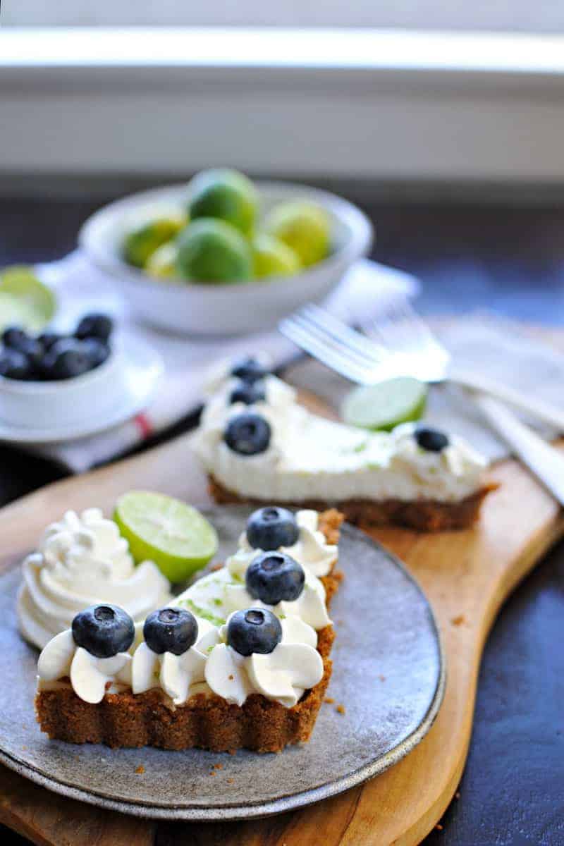 blueberry key lime cheesecake tart with gingersnap crust recipe via thepigandquill.com | #baking #sweets #dessert #summer