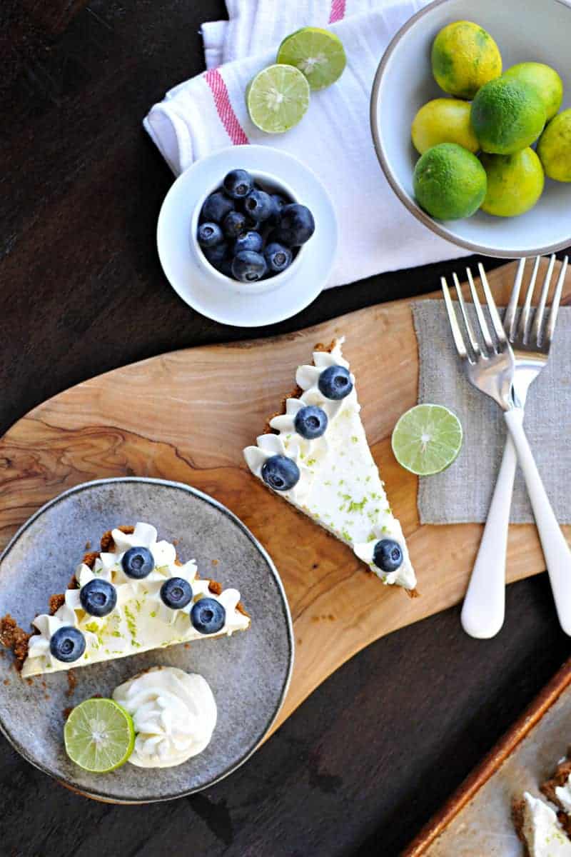 blueberry key lime cheesecake tart with gingersnap crust recipe via thepigandquill.com | #baking #sweets #dessert #summer