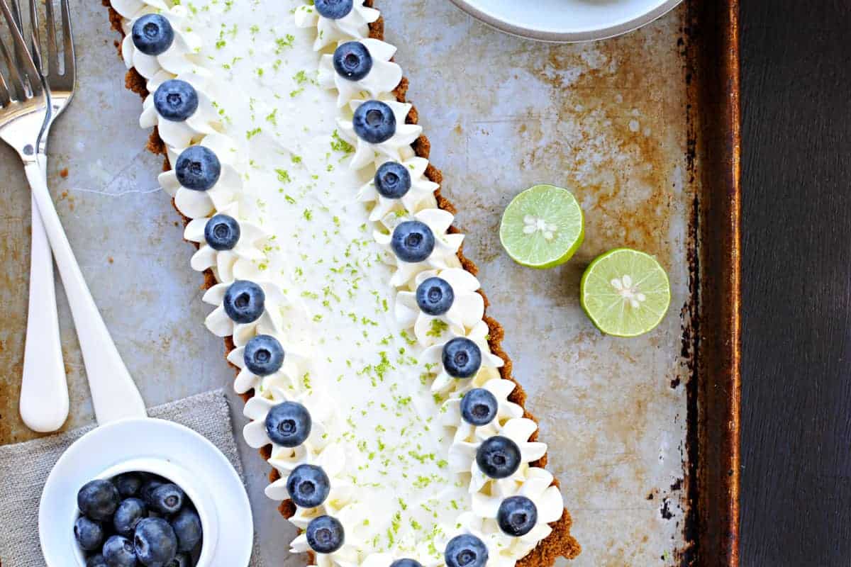 blueberry key lime cheesecake tart with gingersnap crust recipe via thepigandquill.com | #baking #sweets #dessert #summer