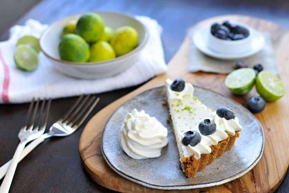 blueberry key lime cheesecake tart with gingersnap crust recipe via thepigandquill.com | #baking #sweets #dessert #summer