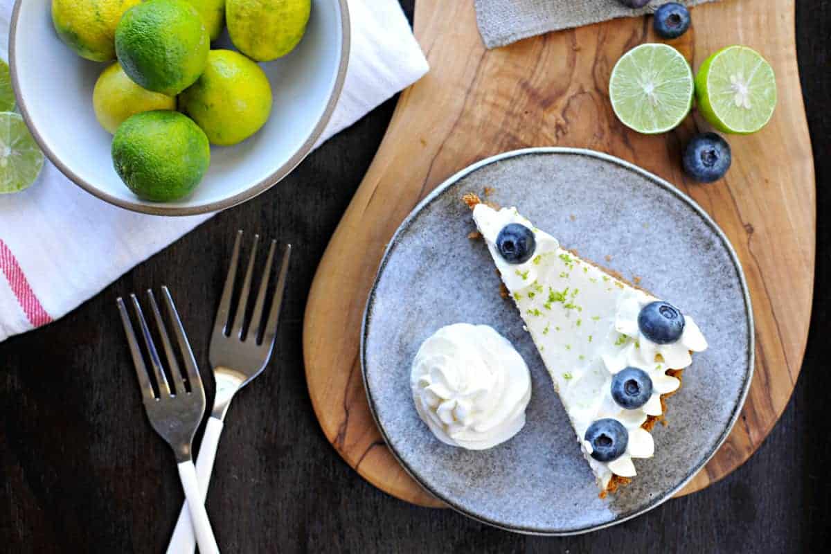 blueberry key lime cheesecake tart with gingersnap crust recipe via thepigandquill.com | #baking #sweets #dessert #summer